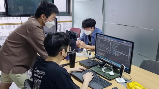 Image of people working at computer. 