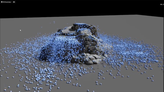 A 3D image showing how simulated blue marble-like objects react when dropped against a rock-like formation. 