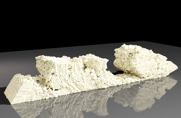A 3D image of beige foam-like particles being formed and deformed to simulate granular sand movement.