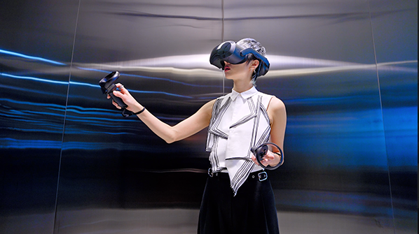 Woman using a VR headset in an empty room.