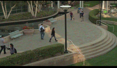 Picture shows pedestrians in a public courtyard.