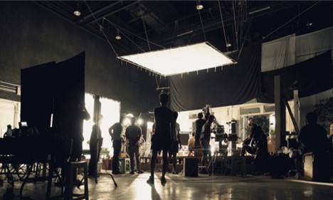 Picture of a production studio with multiple camera and light sources.