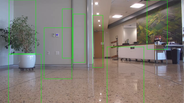 Indoor rooms and hallways with multiple doors where object detection model made many false positive predictions of green bounding boxes 