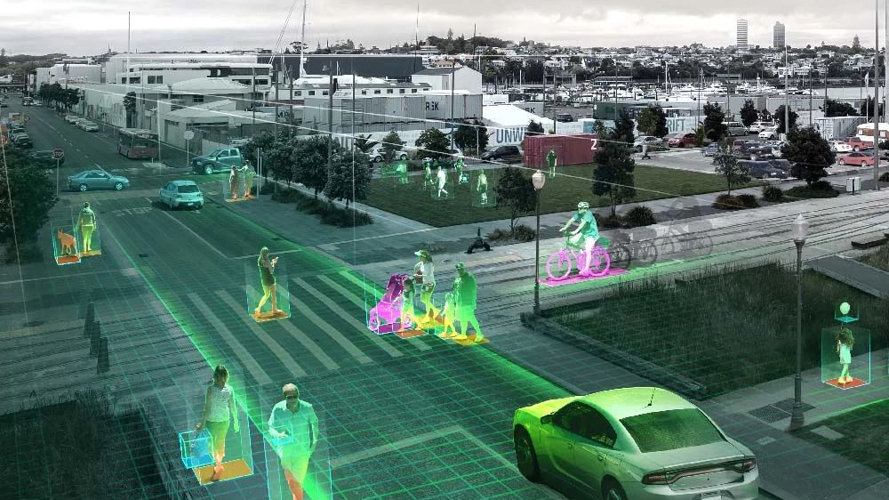 A digitalized street with cars, bikes and pedestrians.