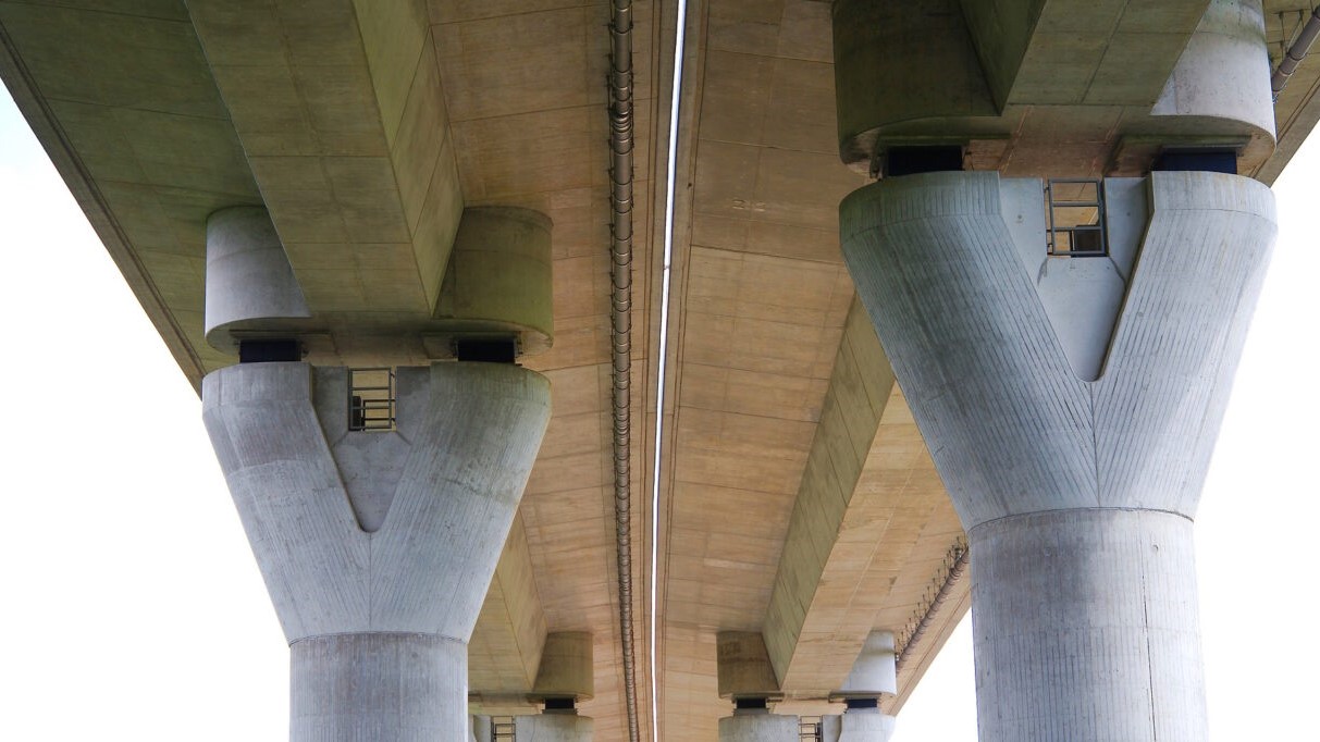 Image of the underside of a bridge, with support pillars.