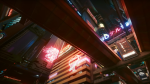 Image of a city street at night with neon signs.