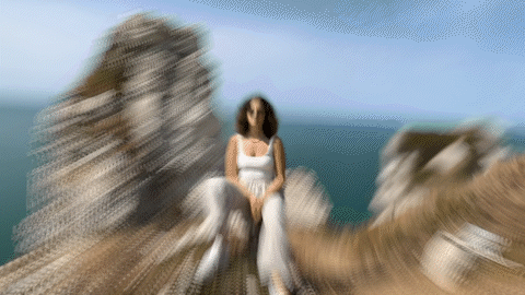 GIF of a woman sitting on a cliff.