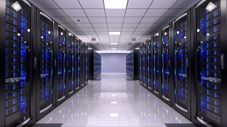 Picture of an aisle in a data center, with servers on either side.