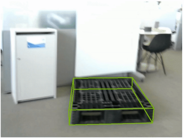A gif of the pallet detection model running in real time detecting a single black plastic pallet.  The video is shaky and blurry, demonstrating the ability of the model to detect the pallet even under adverse conditions.
