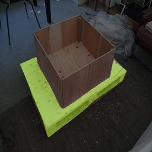 An image showing a single pallet with a box on top. ?The pallet is highlighted in green to show the semantic segmentation result.