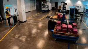 GIF of factory floor with people, pallets, and equipment in bounding boxes.