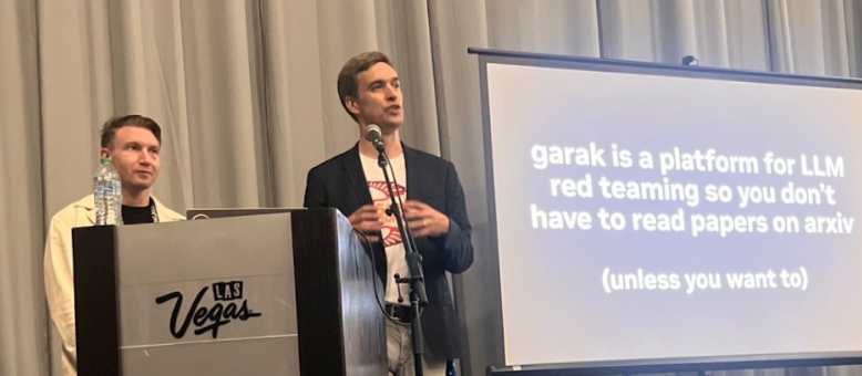 Erick Galinkin and Leon Derczynski deliver a talk from behind a podium to the DEF CON audience. The screen reads, “garak is a platform for LLM red-teaming so you don’t have to read papers on arxiv (unless you want to.”
