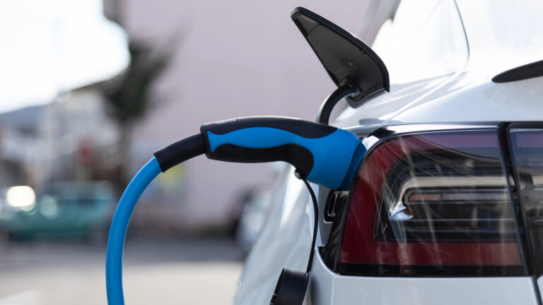 A close-up image of an electric vehicle charging.