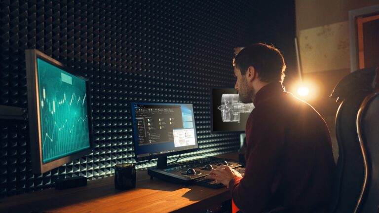 A person looking at a computer monitor.