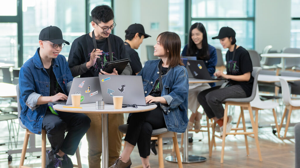 Students sitting around a computer.