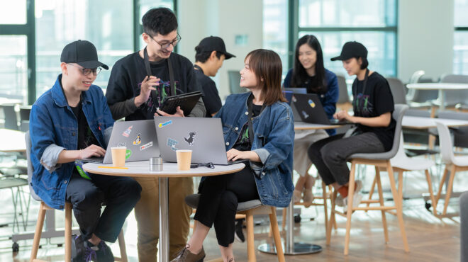 Students sitting around a computer.